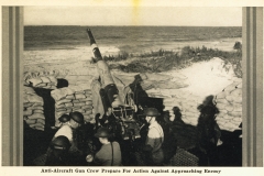 Anti-aircraft gun and crew prepare for action against approaching enemy