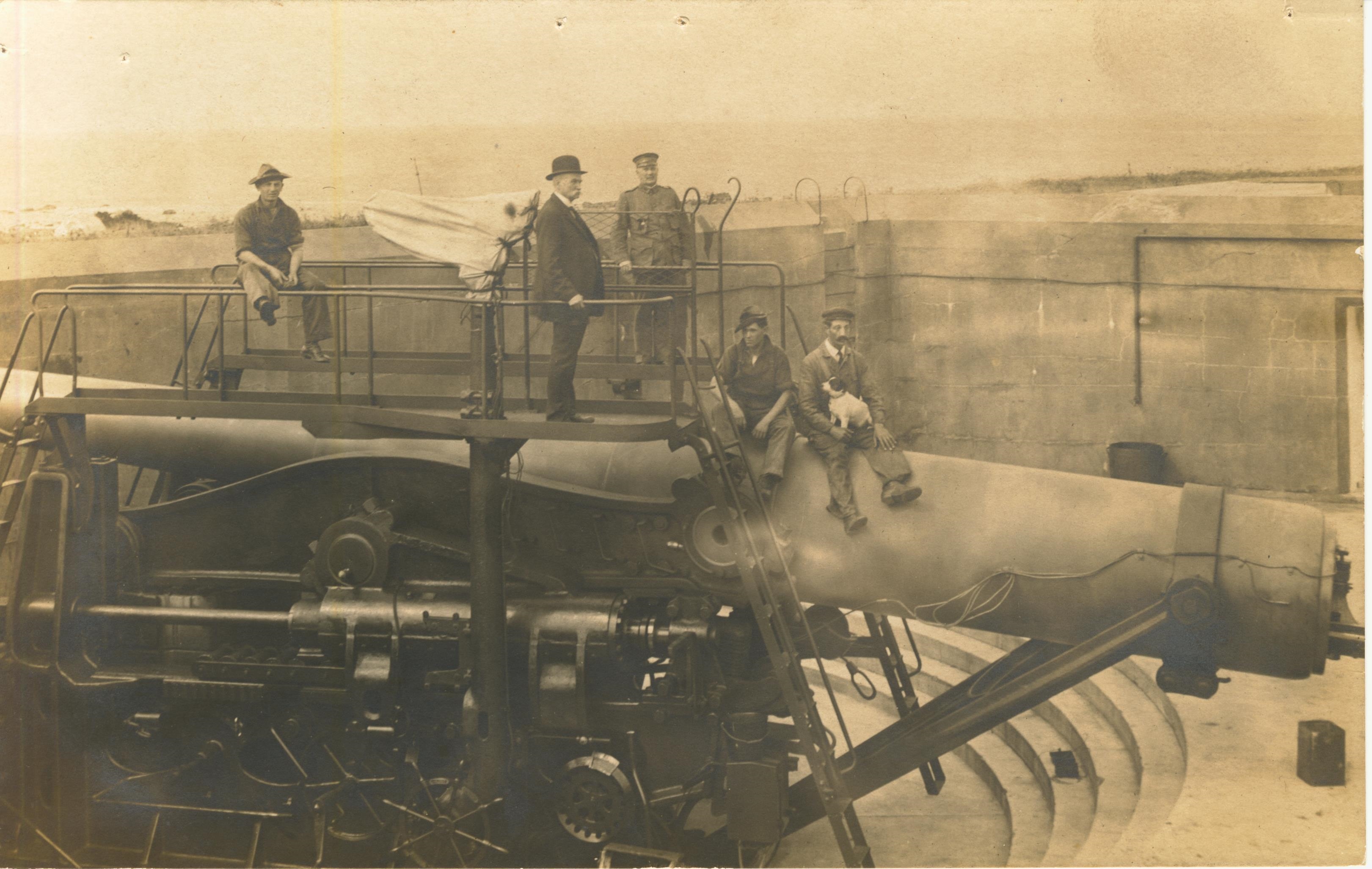 Men and dog on disappearing gun