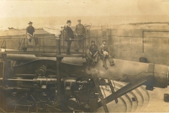 Men and dog on disappearing gun